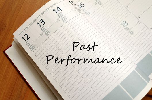 Past performance text concept write on notebook with pen