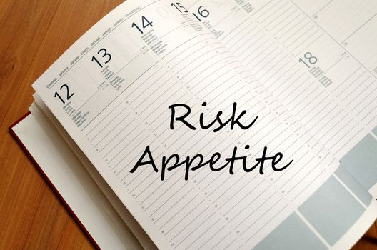 Risk appetite text concept write on notebook with pen