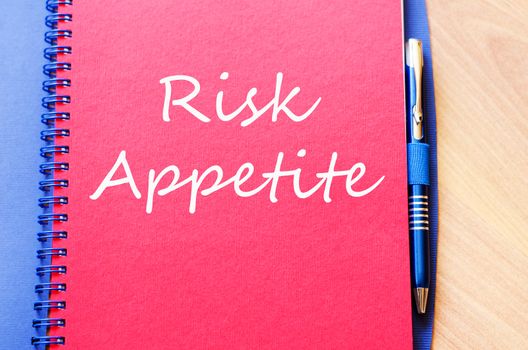 Risk appetite text concept write on notebook with pen