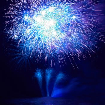 Blue colorful fireworks on the black sky background