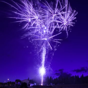 Blue colorful fireworks on night sky background