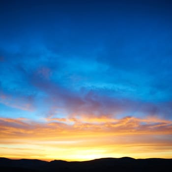 Land with and dramatic colorful sky at sunset