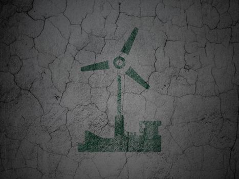 Manufacuring concept: Green Windmill on grunge textured concrete wall background