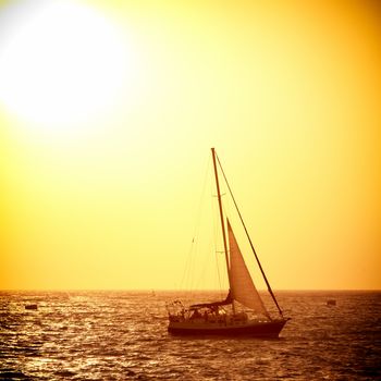 Sail boat against sea sunset. Colorful marine landscape.