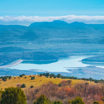 Blue mountains during sunset with lake in a valley