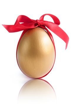 Gold egg tied with red ribbon over a white background