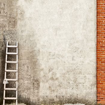 weathered stucco wall background, ladder near the wall