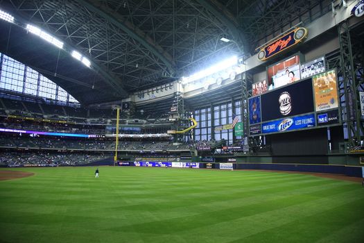 Brewers fans await a baseball game at Miller Park against the Chicago Cubs under a closed dome .