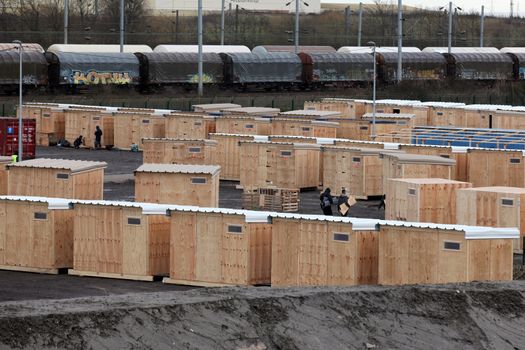 FRANCE, Grande-Synthe: Dozens of new wooden structures are pictured at the new camp at Grande Synthe on March 7, 2016.The new camp features make shift shelters to provide more protection from the elements. Also available are better sanitation measures including showers and toilets. France opened its first international-standard refugee camp in the teeth of official opposition on March 7 while demolition continued at the nearby Calais Jungle camp. The new camp, featuring some 200 heated wooden cabins and proper toilets and showers, has been built by Doctors Without Borders (MSF) with the support of the local town hall, despite opposition from the French government.
