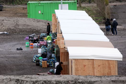 FRANCE, Grande-Synthe: Migrants and refugees arrive in the first international-standard refugee camp on March 7, 2016 in Grande-Synthe, northern France.France opened its first international-standard refugee camp in the teeth of official opposition on March 7 while demolition continued at the nearby Calais Jungle camp. The new camp, featuring some 200 heated wooden cabins and proper toilets and showers, has been built by Doctors Without Borders (MSF) with the support of the local town hall, despite opposition from the French government.