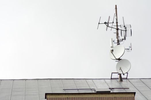 TV antennas and satellites on the roof of the house