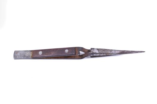Old metal tweezers isolated on a white background