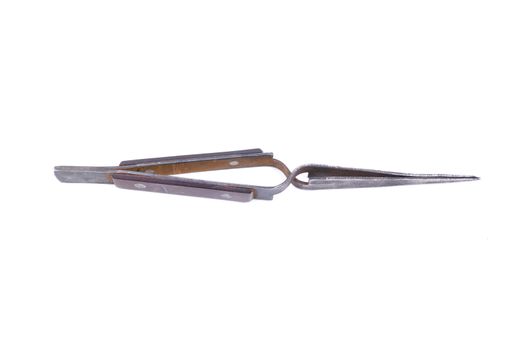Old metal tweezers isolated on a white background