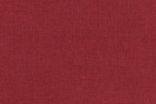 Dark red knitted fabric texture closeup, useful as background