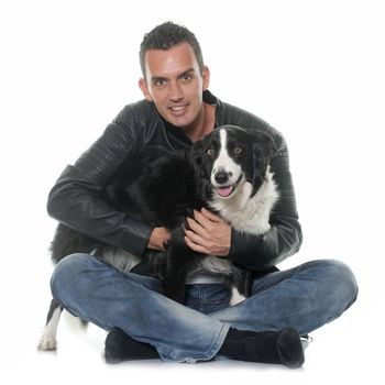 man and border collie in front of white background