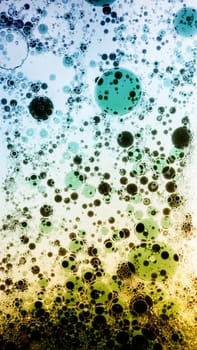 Oil drops in colorful formations on water surface