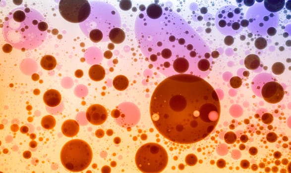 Oil drops in colorful formations on water surface