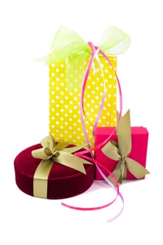 Luxury gift boxes with satin ribbon and bow isolated over white background.