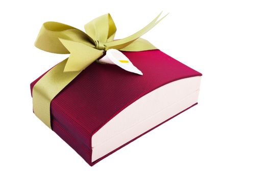 Luxury gift box in dark red shades with green satin ribbon and bow isolated over white background.