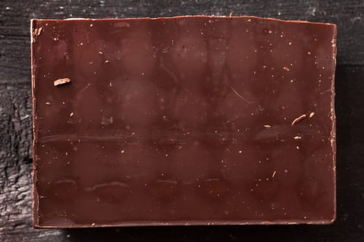 Dark chocolate bar on wooden background