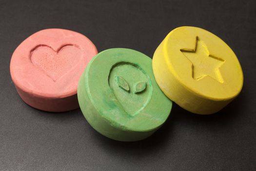 Ecstasy tablets on black background