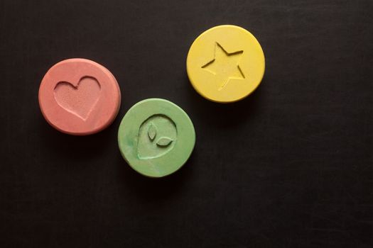 Ecstasy tablets on black background