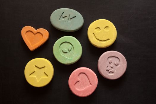 Ecstasy tablets on black background