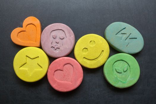 Ecstasy tablets on black background