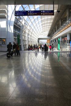 Hong Kong, Hong Kong S.A.R. - December 29, 2014: Passengers in the airport main lobby in Hong Kong, China. The Hong Kong airport handles more than 70 million passengers per year.