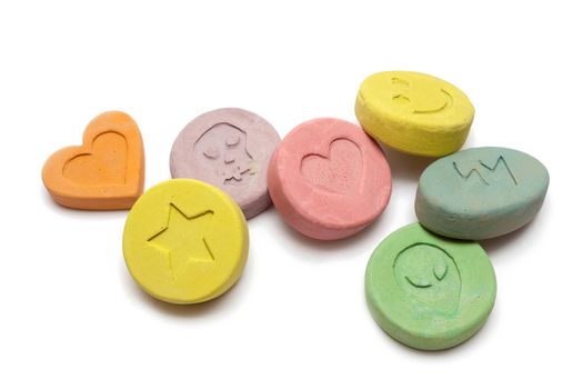 Ecstasy tablets on white background