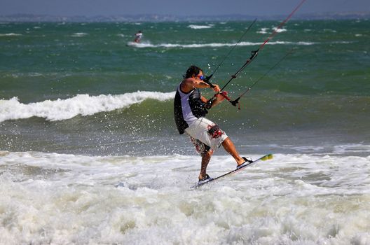 Kiteboarder enjoy surfing in ocean. Vietnam