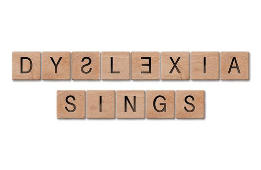 Wooden letters spelling dyslexia signs on white background