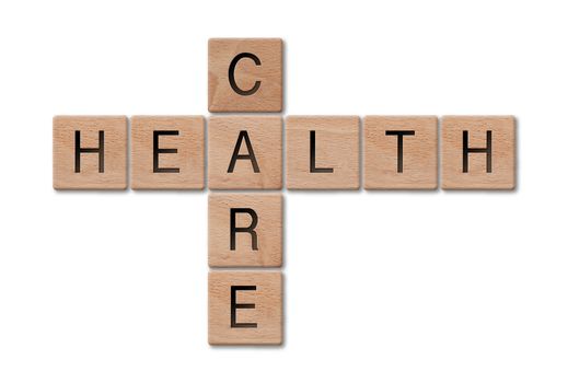 Wooden letters spelling health care on white background