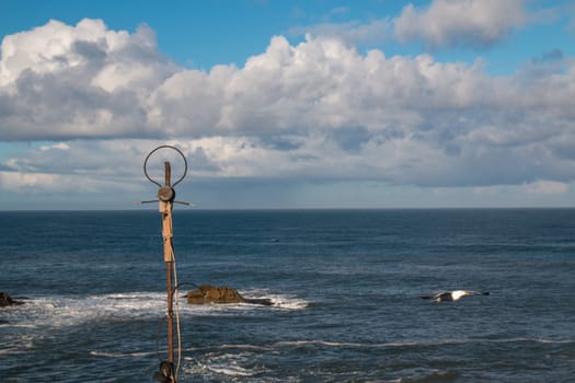 Homemade antenna in the foreground, horizon of moroccan part of Atlantic Ocean and intense cloudy sky in the background.