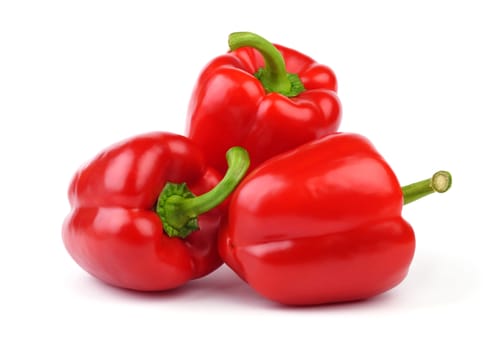 Three whole red sweet peppers isolated on white background.