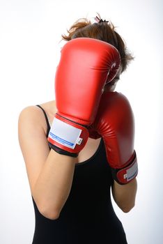 asian woman with the red boxing gloves guard her face on white background