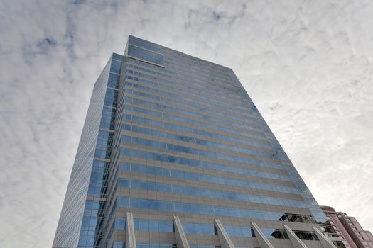 Modern Glass Retail and Office Tower against white cloudy sky in downtown Portland Oregon