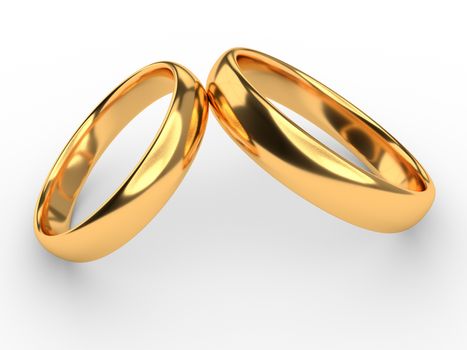 Two wedding gold rings lie on each other isolated on white