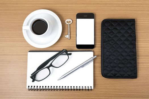 coffee and phone with notepad,key,eyeglasses and wallet on wood table background