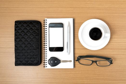 coffee and phone with notepad,car key,eyeglasses and wallet on wood table background