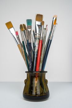 Photo of artist paint brushes in a jar