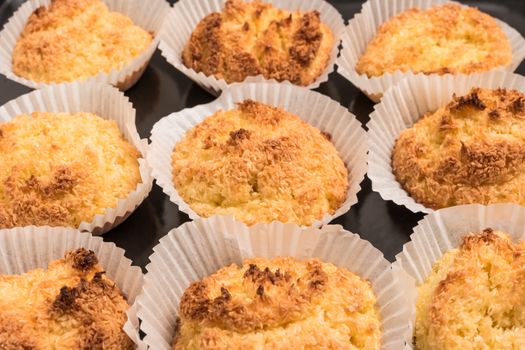 Close up of homemade coconut macaroons, cookie recipe in the oven.