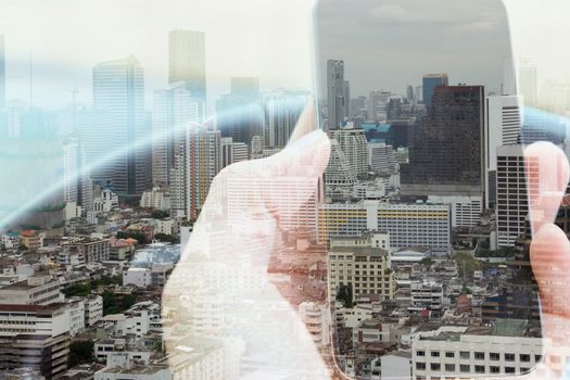 Double exposure of man using smart phone and cityscape background, urban lifestyle and Business technology concept.