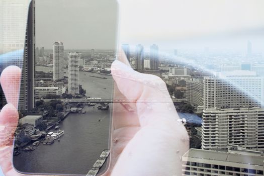 Double exposure of man using smart phone and cityscape background, urban lifestyle and Business technology concept.