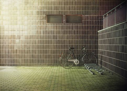 vintage bicycle near the concrete wall with ventilation hole