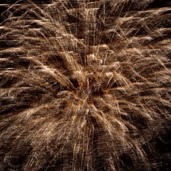 Abstract yellow fireworks on the black sky background. Holiday celebration.