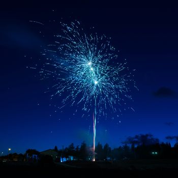 Blue colorful fireworks on night sky background