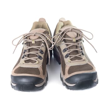 Pair of brown trainers on white isolated background