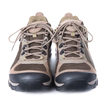 Pair of brown trainers on white isolated background