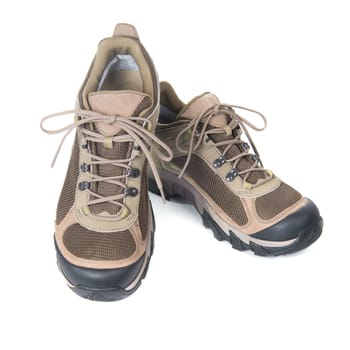 Pair of brown trainers on white isolated background